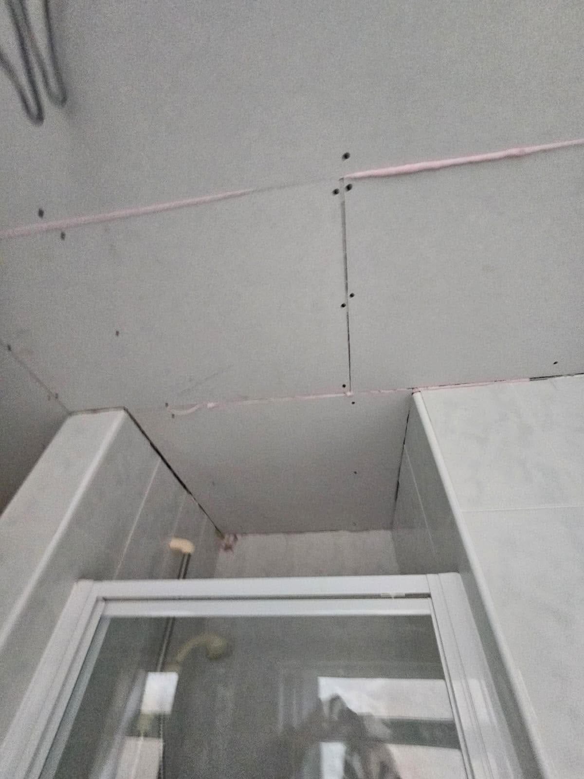 A bathroom ceiling re-boarded above the tiles